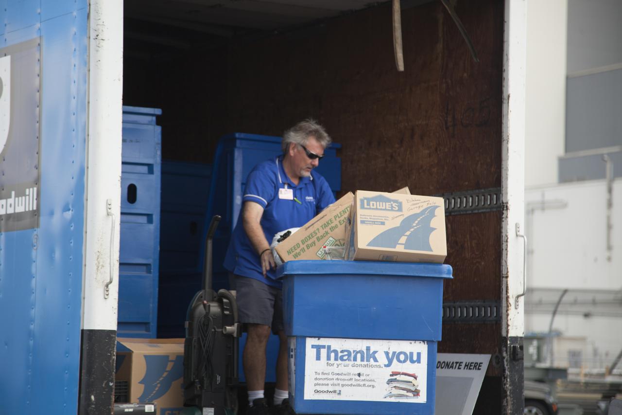 In the parking lot of the Vehicle Assembly Building at NASA's Kennedy Space Center in Florida, a member of Goodwill Industries loads used household material for recycling. During the two-day event, employees dropped off items as part of America Recycles Day. The center partnered with Goodwill Industries and several other local organizations to collect items for reprocessing. The annual event is a program of Keep America Beautiful, dedicated to promoting and celebrating recycling.