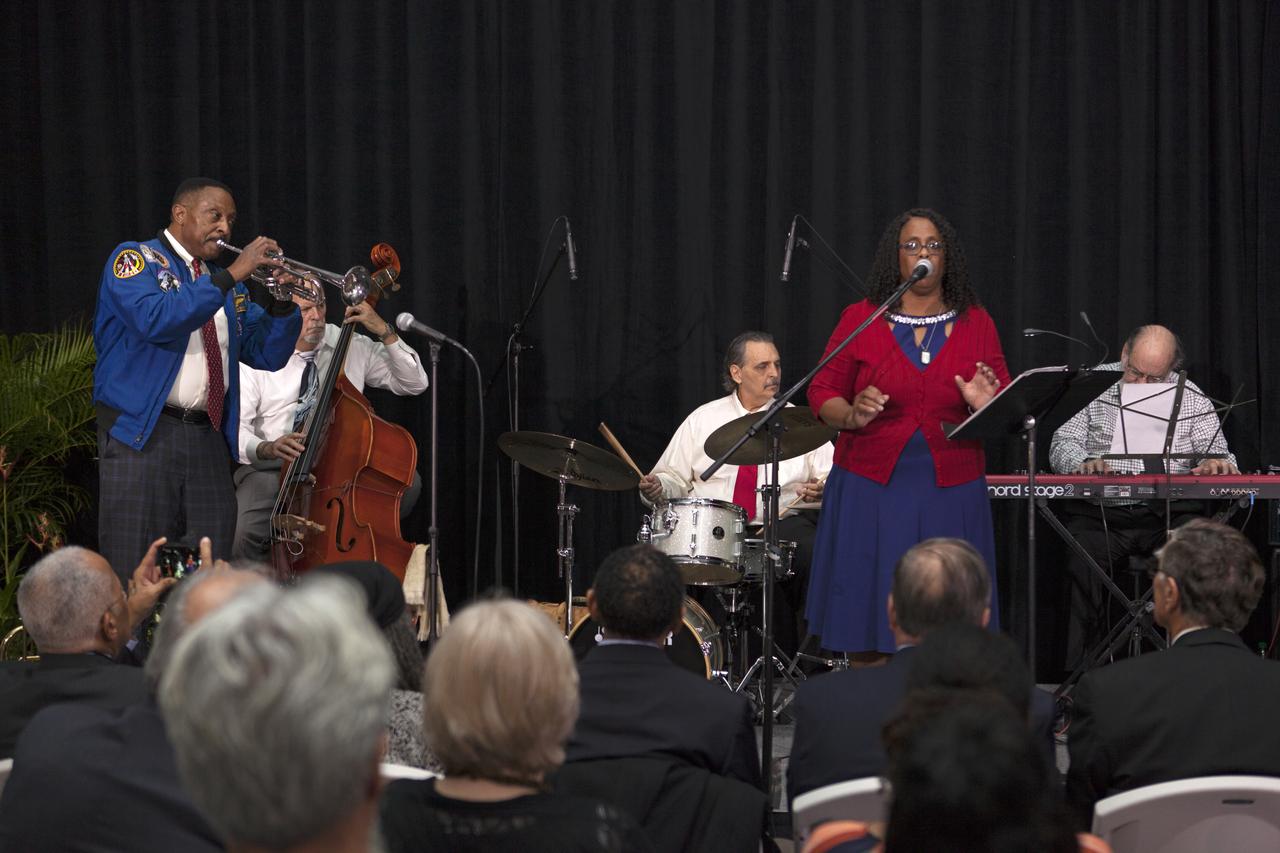 During an Astronauts Memorial Foundation tribute honoring U.S. Air Foce Maj. Robert Lawrence, The Winston Scott “Cosmic Jazz Ensemble” performed. Participants are, from the left, former NASA astronaut Winston Scott playing trumpet, Al Dodds on bass, Stan Soloko playing drums, vocalist Shyrl “Lady Tandy” Johnson, and Ron Teixeira playing piano. Selected in 1967 for the Manned Orbiting Laboratory Program, Lawrence was the first African-American astronaut. He lost his life in a training accident 50 years ago. The ceremony took place in the Center for Space Education at the Kennedy Space Center Visitor Complex.