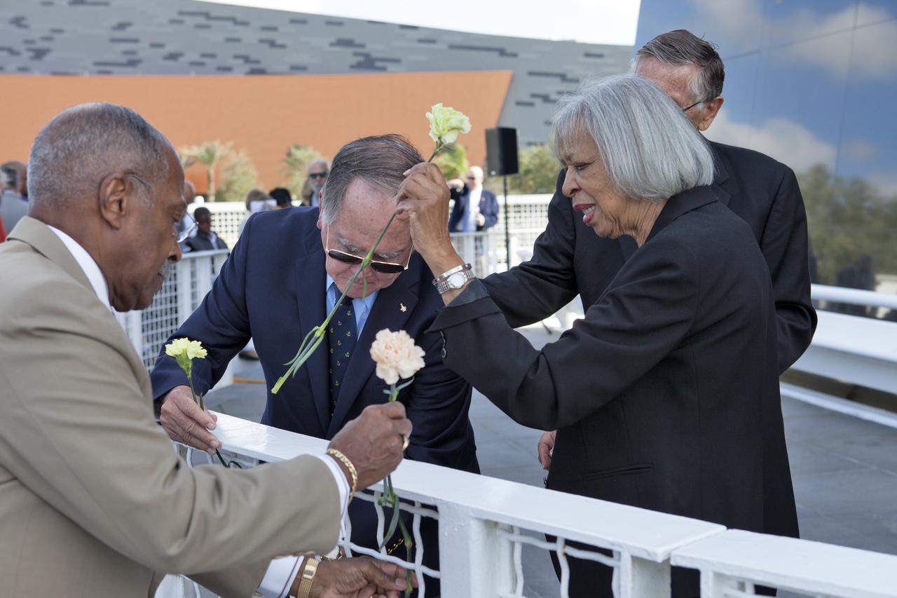 During an Astronauts Memorial Foundation tribute honoring U.S. Air Foce Maj. Robert Lawrence, his sister, Barbara Lawrence, Ph.D., far right, places a flower at the Space Mirror Memorial at the Kennedy Space Center Visitor Complex. Selected in 1967 for the Manned Orbiting Laboratory Program, Lawrence was the first African-American astronaut. He lost his life in a training accident 50 years ago. The ceremony took place in the Center for Space Education at the Kennedy Space Center Visitor Complex.