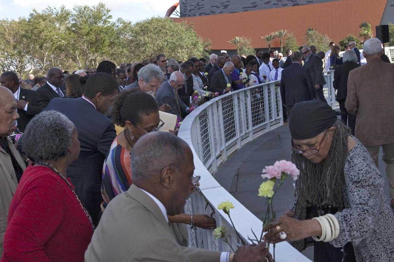 Following an Astronauts Memorial Foundation tribute honoring U.S. Air Foce Maj. Robert Lawrence, guests place flowers at the Space Mirror Memorial at the Kennedy Space Center Visitor Complex. Selected in 1967 for the Manned Orbiting Laboratory Program, Lawrence was the first African-American astronaut. He lost his life in a training accident 50 years ago. The ceremony took place in the Center for Space Education at the Kennedy Space Center Visitor Complex.