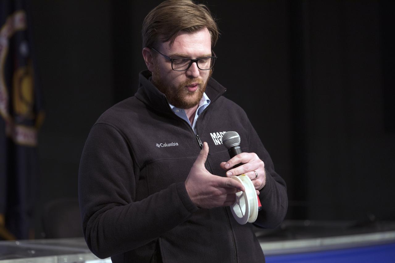 Andrew Rush, president and chief executive officer of Made in Space, discusses his company's Fiber Optics payload, with members of social media in the Kennedy Space Center’s Press Site auditorium. The briefing focused on research planned for launch to the International Space Station. The scientific materials and supplies will be aboard a Dragon spacecraft scheduled for liftoff from Cape Canaveral Air Force Station's Space Launch Complex 40 at 11:46 a.m. EST, on Dec. 12, 2017. The SpaceX Falcon 9 rocket will launch the company's 13th Commercial Resupply Services mission to the space station.