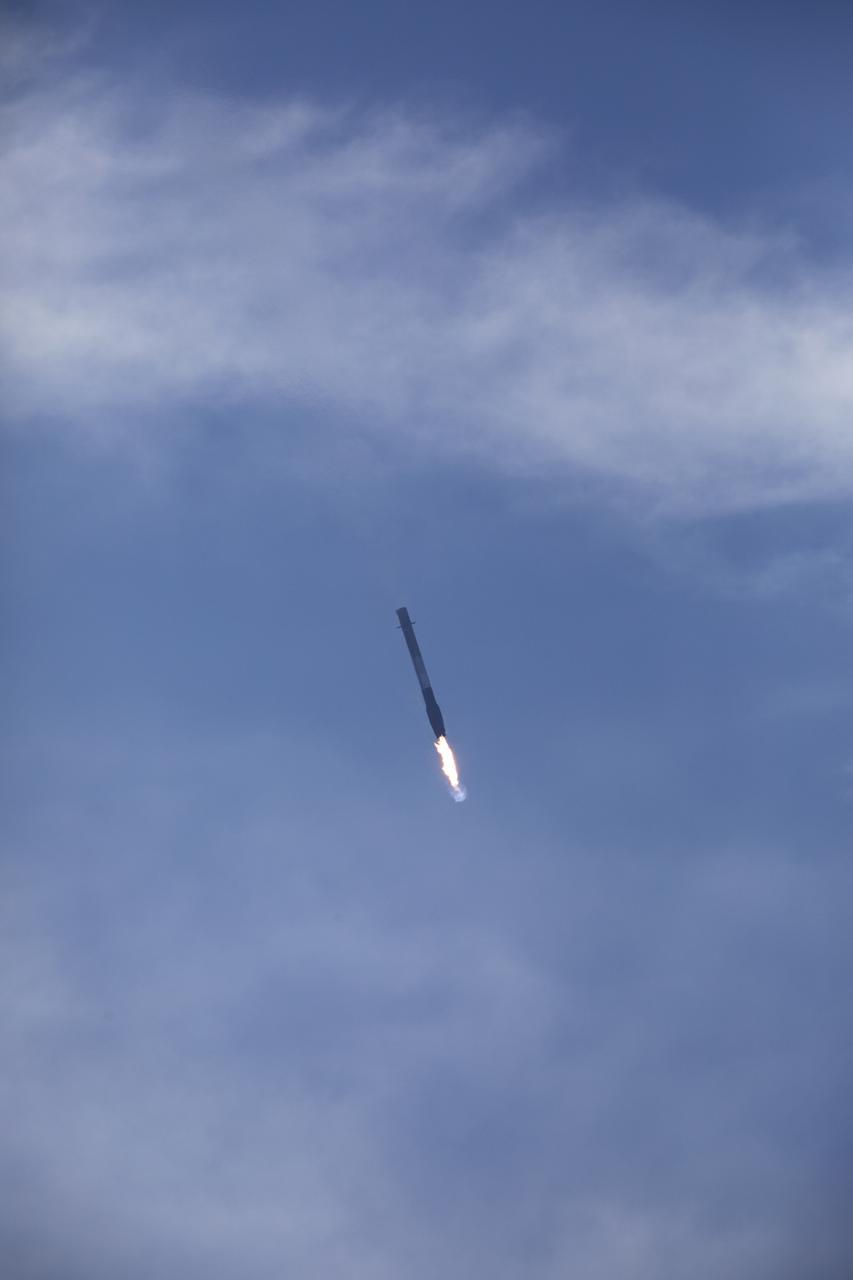 After boosting a Dragon spacecraft on its way to the International Space Staton for the SpaceX CRS-13 mission, the Falcon 9 first stage returns to Landin Zone 1 at Cape Canaveral Air Force Station. The rocket lifted off moments earlier from Space Launch Complex 40 at the Cape on the company's 13th commercial resupply services mission to the space station. Dragon will deliver additional supplies and research experiments that improve life on Earth and drive progress toward future space exploration.