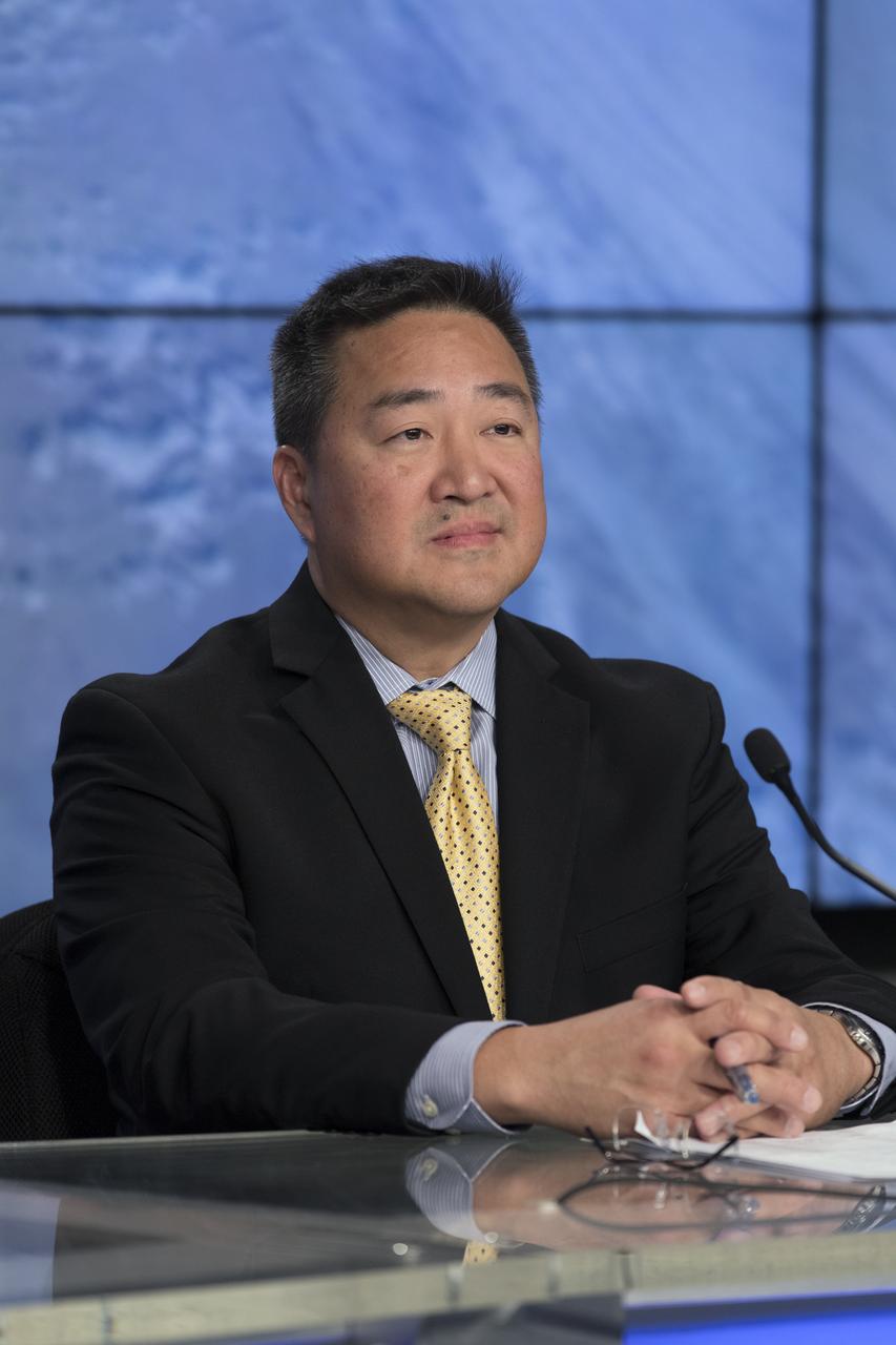 In the Press Site auditorium of NASA's Kennedy Space Center in Florida, from left, Ven Feng, manager of the Transportation Integration Office for the International Space Station Program, speaks to media at a post-launch news conference following the liftoff of SpaceX CRS-13. The flight is a commercial resupply services mission to the International Space Station. SpaceX CRS-13 lifted off atop a Falcon 9 rocket from Space Launch Complex 40 at Cape Canaveral Air Force Station at 10:36 a.m. EST with supplies and equipment and new science experiments for technology research.
