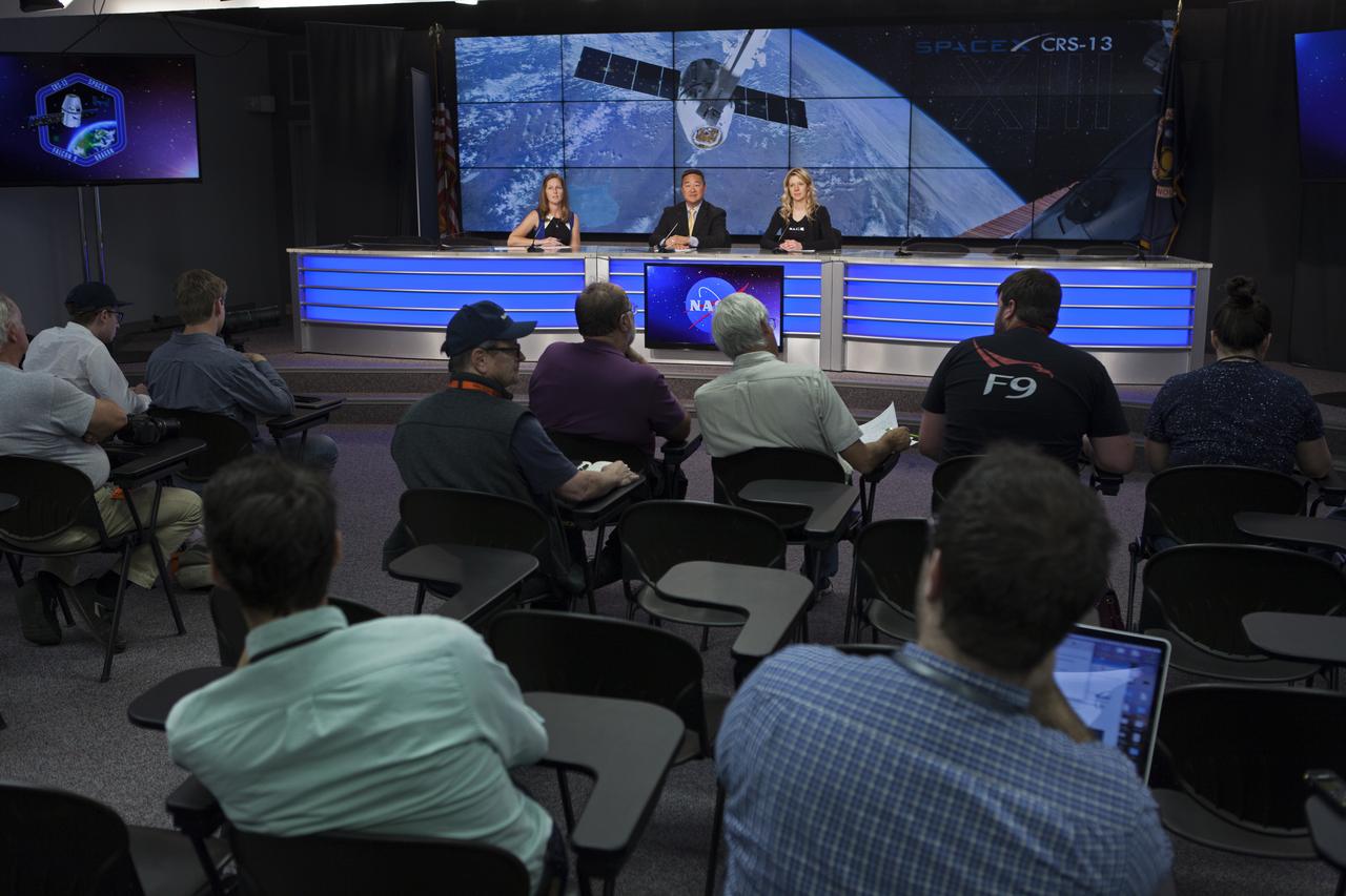 In the Press Site auditorium of NASA's Kennedy Space Center in Florida, from left, Stephanie Martin of NASA Communications, Ven Feng, manager of the Transportation Integration Office for the International Space Station Program, and Jessica Jensen, SpaceX director of Dragon Mission Management, speak to media at a post-launch news conference following the liftoff of SpaceX CRS-13. The flight is a commercial resupply services mission to the International Space Station. SpaceX CRS-13 lifted off atop a Falcon 9 rocket from Space Launch Complex 40 at Cape Canaveral Air Force Station at 10:36 a.m. EST with supplies and equipment and new science experiments for technology research.