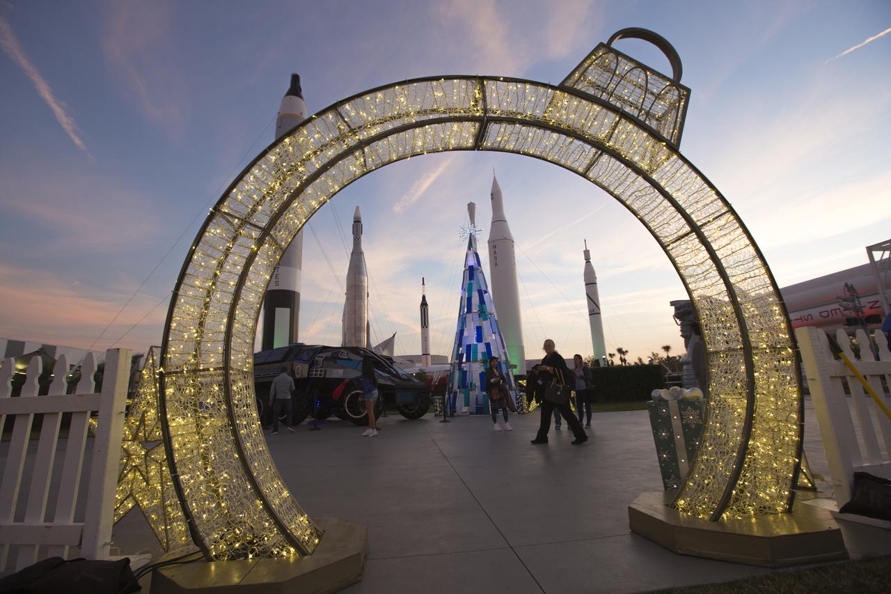The Rocket Garden at the Kennedy Space Center Visitor Complex in Florida is visible through an ornament-shaped doorway set up for Holidays in Space 2017. The event kicked off Dec. 20 with a dazzling performance by the dance group Fighting Gravity, followed by a fireworks finale. Holidays in Space 2017 includes nightly performances from Dec. 20 through 31, excluding Dec. 25.