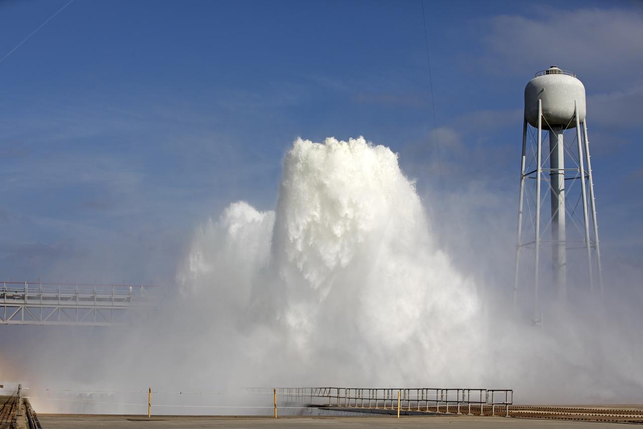 About 450,000 gallons of water flowed at high speed from a holding tank through new and modified piping and valves, the flame trench, flame deflector nozzles and mobile launcher interface risers during a wet flow test at Launch Pad 39B at NASA's Kennedy Space Center in Florida. At peak flow, the water reached about 100 feet in the air above the pad surface. The test was a milestone to confirm and baseline the performance of the Ignition Overpressure/Sound Suppression system. During launch of NASA's Space Launch System rocket and Orion spacecraft, the high-speed water flow will help protect the vehicle from the extreme acoustic and temperature environment during ignition and liftoff.