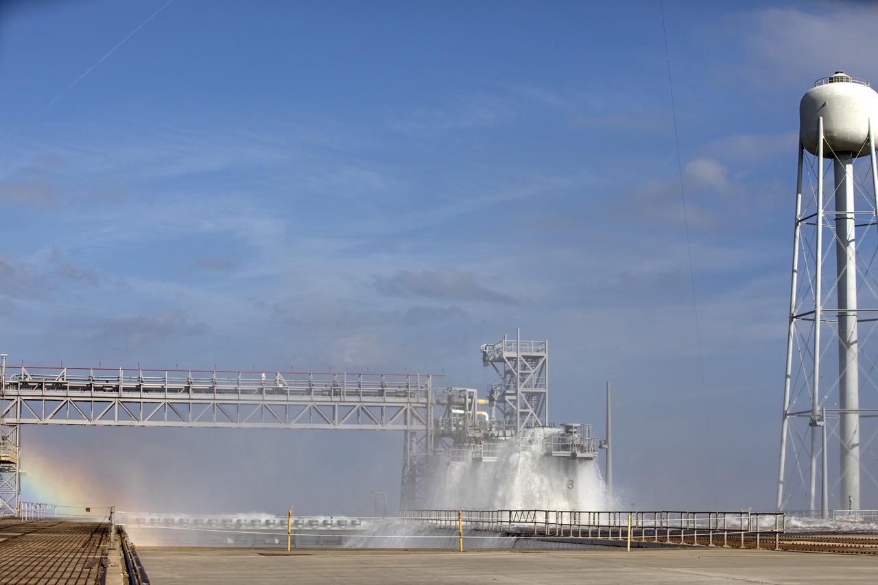 About 450,000 gallons of water flowed at high speed from a holding tank through new and modified piping and valves, the flame trench, flame deflector nozzles and mobile launcher interface risers during a wet flow test at Launch Pad 39B at NASA's Kennedy Space Center in Florida. At peak flow, the water reached about 100 feet in the air above the pad surface. The test was a milestone to confirm and baseline the performance of the Ignition Overpressure/Sound Suppression system. During launch of NASA's Space Launch System rocket and Orion spacecraft, the high-speed water flow will help protect the vehicle from the extreme acoustic and temperature environment during ignition and liftoff.