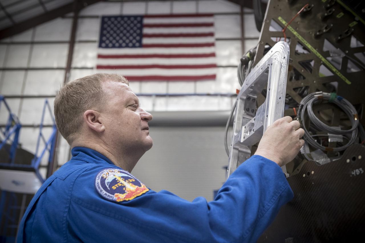 Astronaut Eric Boe examines hardware during a tour of the SpaceX facility in Hawthorne, California. SpaceX is developing its Crew Dragon spacecraft and Falcon 9 rocket in partnership with NASA’s Commercial Crew Program to carry astronauts to and from the International Space Station.