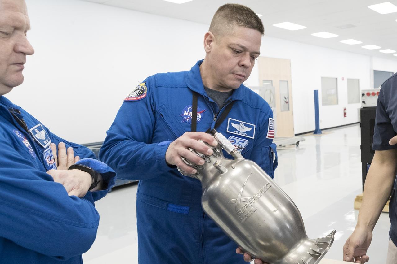 Astronaut Bob Behnken examines a SuperDraco engine during a tour of the SpaceX facility in Hawthorne, California. SpaceX is developing its Crew Dragon spacecraft and Falcon 9 rocket in partnership with NASA’s Commercial Crew Program to carry astronauts to and from the International Space Station.