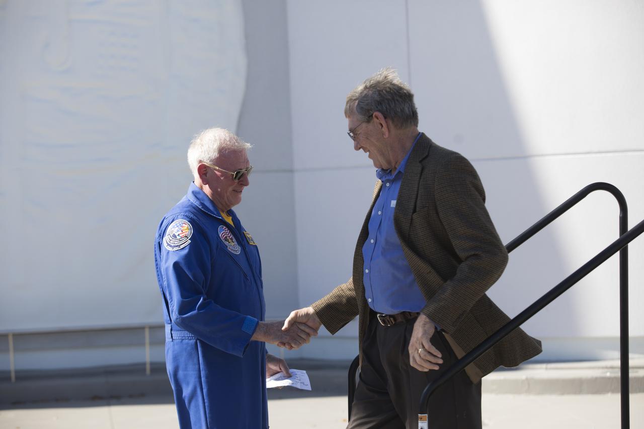 Former NASA astronaut Jon McBride, left, greets Mike McCulley during a ceremony at the Heroes and Legends exhibit at the Kennedy Space Center Visitor Complex. The brief memorial honoring NASA astronaut John Young took place on the afternoon of Jan. 11, 2018. Young died Jan. 5, 2018, in Houston at the age of 87. He was the only astronaut to fly in NASA's Gemini, Apollo and Space Shuttle Programs.