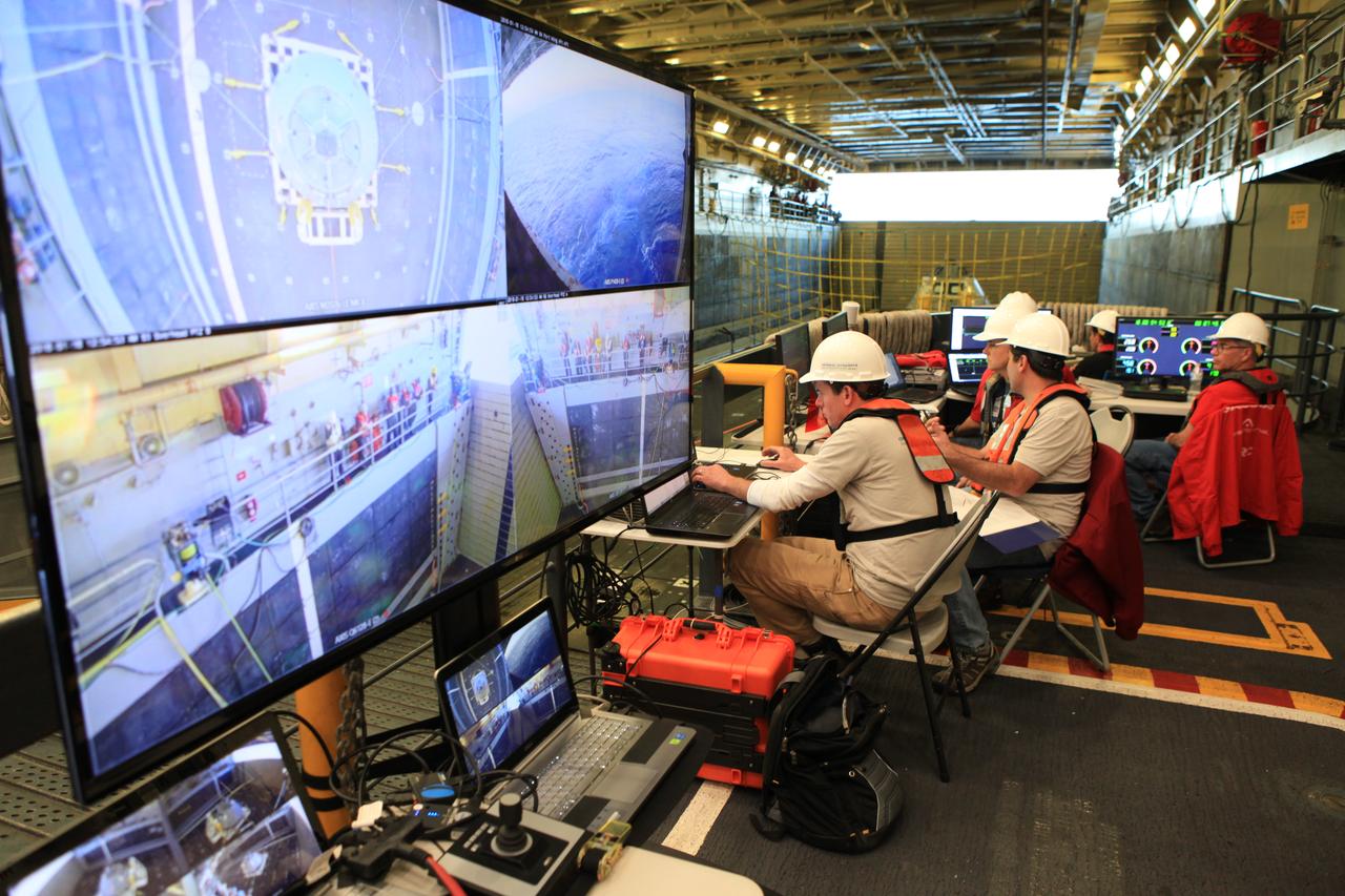 Members of the Wave Monitoring System check their data during the Underway Recovery Test 6, or URT-6, aboard the USS Anchorage. The testing with Kennedy Space Center’s NASA Recovery Team and the U.S. Navy will provide important data that is being used to improve recovery procedures and hardware ahead of Orion’s next flight, Exploration Mission-1, when it splashes down in the Pacific Ocean.