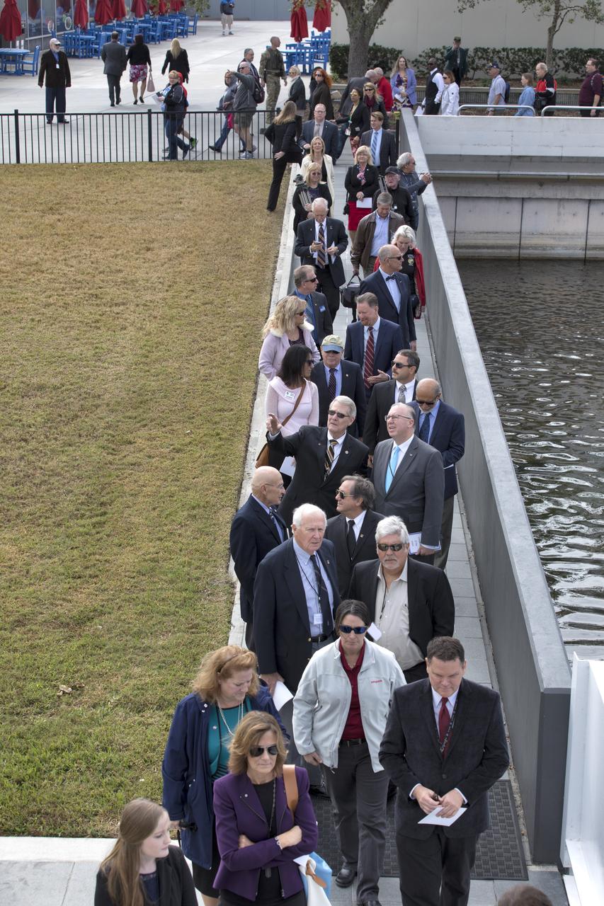 Following this year's Day of Remembrance ceremony at the Kennedy Space Center Visitor Complex, guests walk to the Space Mirror Memorial. The names of fallen astronauts from Apollo 1, Challenger and Columbia, as well as the astronauts who perished in training and commercial airplane accidents are emblazoned on the monument. Each year spaceport employees and guests join others throughout NASA honoring the contributions of astronauts who have perished in the conquest of space.