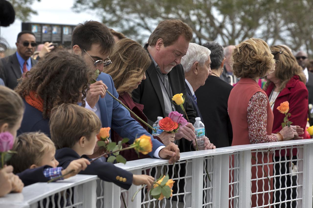 Guests place flowers near the Space Mirror Memorial at the Kennedy Space Center Visitor Complex. The names of fallen astronauts from Apollo 1, Challenger and Columbia, as well as the astronauts who perished in training and commercial airplane accidents are emblazoned on the monument. During the annual Day of Remembrance, spaceport employees and guests join others throughout NASA honoring the contributions of astronauts who have perished in the conquest of space.