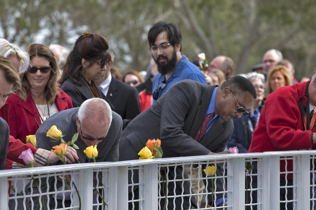 Guests place flowers near the Space Mirror Memorial at the Kennedy Space Center Visitor Complex. The names of fallen astronauts from Apollo 1, Challenger and Columbia, as well as the astronauts who perished in training and commercial airplane accidents are emblazoned on the monument. During the annual Day of Remembrance, spaceport employees and guests join others throughout NASA honoring the contributions of astronauts who have perished in the conquest of space.