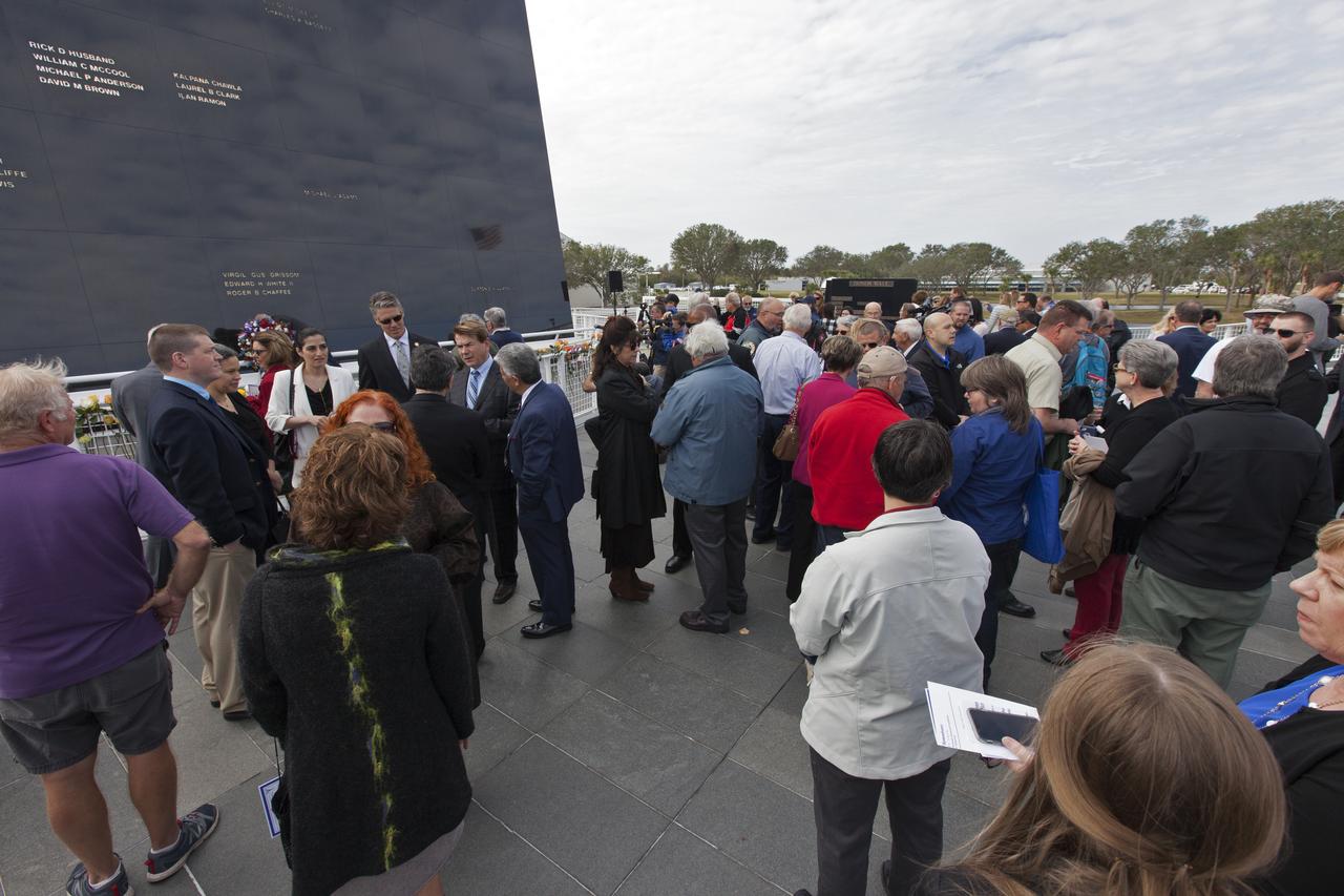 Guests gather near the Space Mirror Memorial at the Kennedy Space Center Visitor Complex. The names of fallen astronauts from Apollo 1, Challenger and Columbia, as well as the astronauts who perished in training and commercial airplane accidents are emblazoned on the monument. During the annual Day of Remembrance, spaceport employees and guests join others throughout NASA honoring the contributions of astronauts who have perished in the conquest of space.