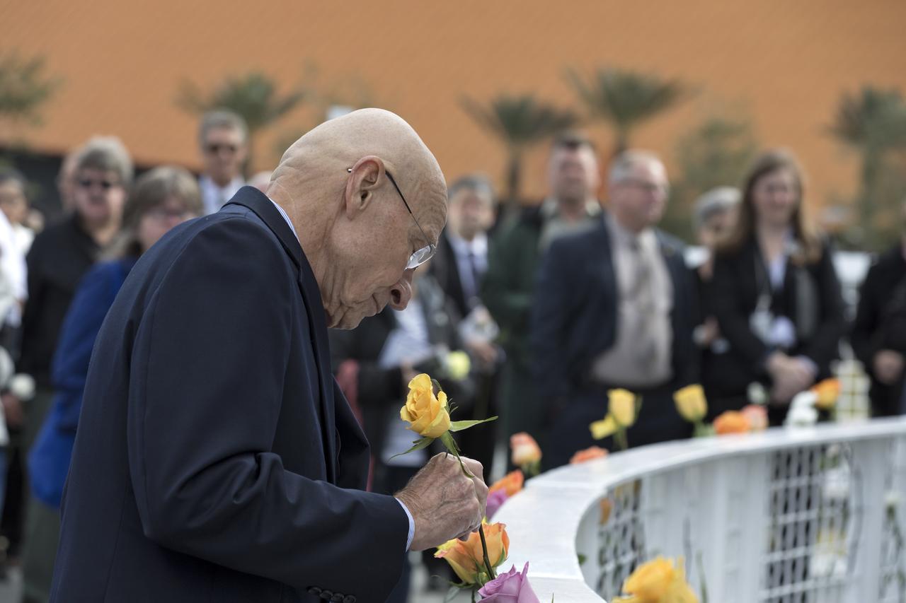Guests place flowers near the Space Mirror Memorial at the Kennedy Space Center Visitor Complex. The names of fallen astronauts from Apollo 1, Challenger and Columbia, as well as the astronauts who perished in training and commercial airplane accidents are emblazoned on the monument. During the annual Day of Remembrance, spaceport employees and guests join others throughout NASA honoring the contributions of astronauts who have perished in the conquest of space.