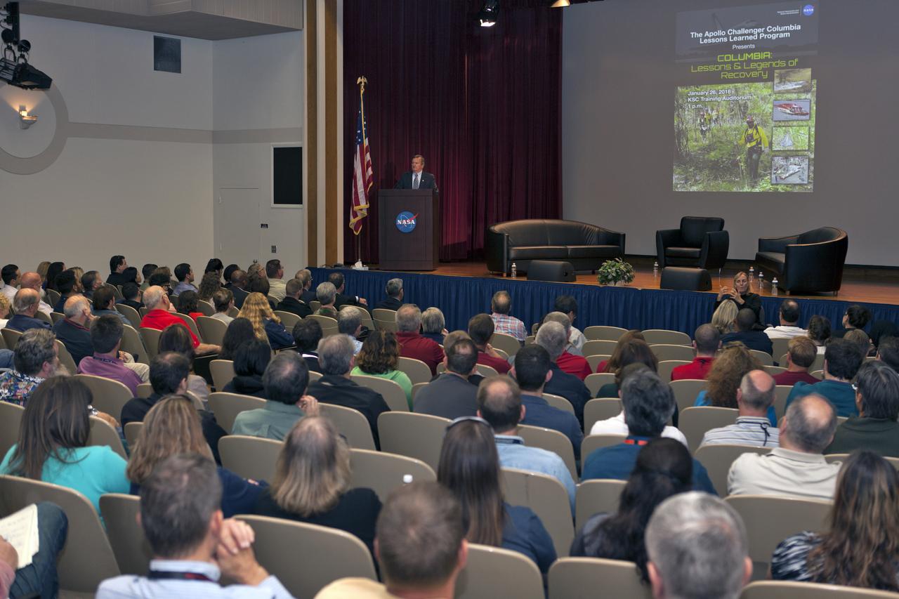 Former NASA Shuttle Launch Director Mike Leinbach speaks to employees during an Apollo, Challenger, Columbia Lessons Learned Program event in the Training Auditorium at Kennedy Space Center in Florida. The program's theme was "Columbia: Lessons and Legends of Recovery." Leinbach participated in a panel discussion during the event.