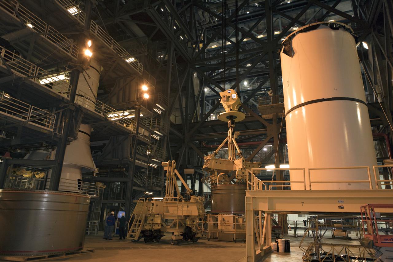 Crane operators and ground support personnel practice lifting and stacking mock-ups of solid rocket booster (SRB) segments in High Bay 4 inside the Vehicle Assembly Building at NASA’s Kennedy Space Center in Florida. The training will help workers prepare for SRB stacking operations for the agency's Space Launch System SLS) rocket. The SLS will launch the Orion spacecraft on its first integrated flight, Exploration Mission-1.