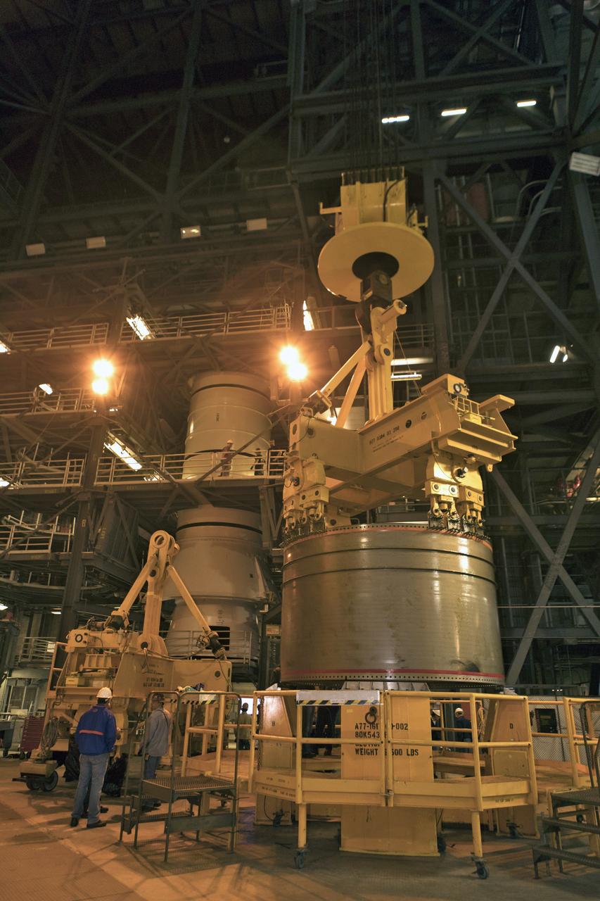 Crane operators and ground support personnel practice lifting and stacking mock-ups of solid rocket booster (SRB) segments in High Bay 4 inside the Vehicle Assembly Building at NASA’s Kennedy Space Center in Florida. The training will help workers prepare for SRB stacking operations for the agency's Space Launch System SLS) rocket. The SLS will launch the Orion spacecraft on its first integrated flight, Exploration Mission-1.