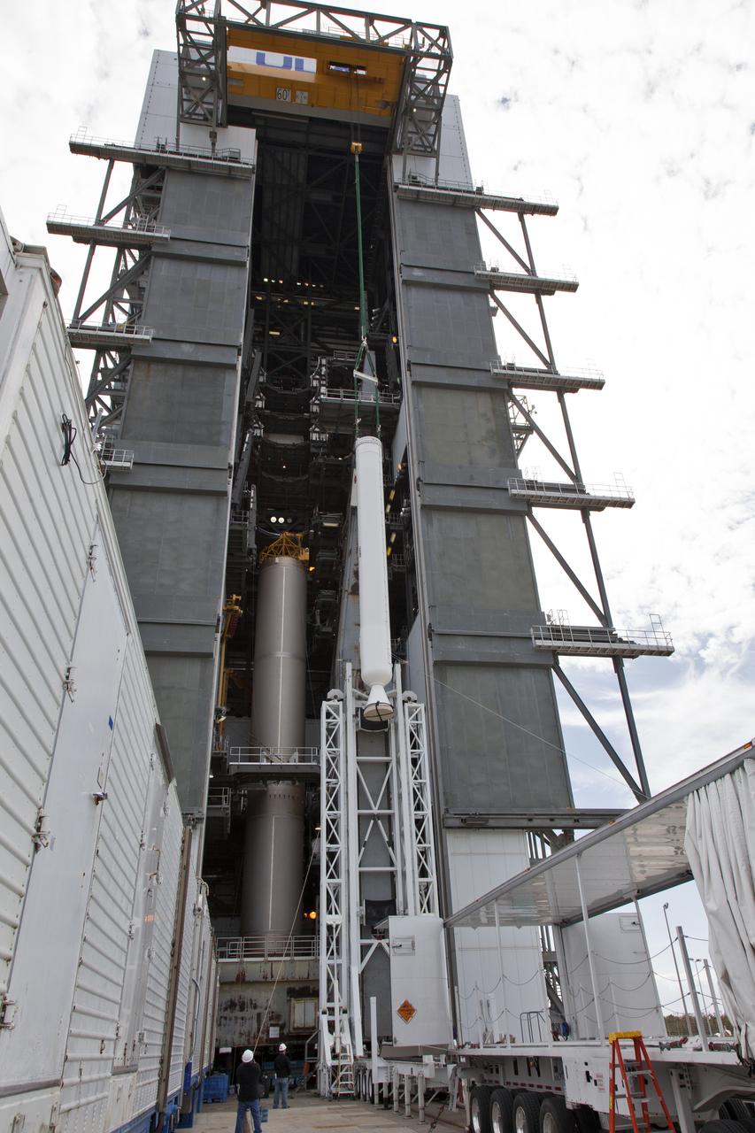 A crane lifts a solid rocket booster (SRB) for mating to a United Launch Alliance Atlas V first stage in the Vertical Integration Facility at Space Launch Complex 41 at Cape Canaveral Air Force Station in Florida. The SRB will be help boost NOAA's Geostationary Operational Environmental Satellite, or GOES-S, to orbit. GOES-S is the second in a series of four advanced geostationary weather satellites that will significantly improve the detection and observation of environmental phenomena that directly affect public safety, protection of property and the nation's economic health and prosperity. GOES-S is slated to launch March 1, 2018.
