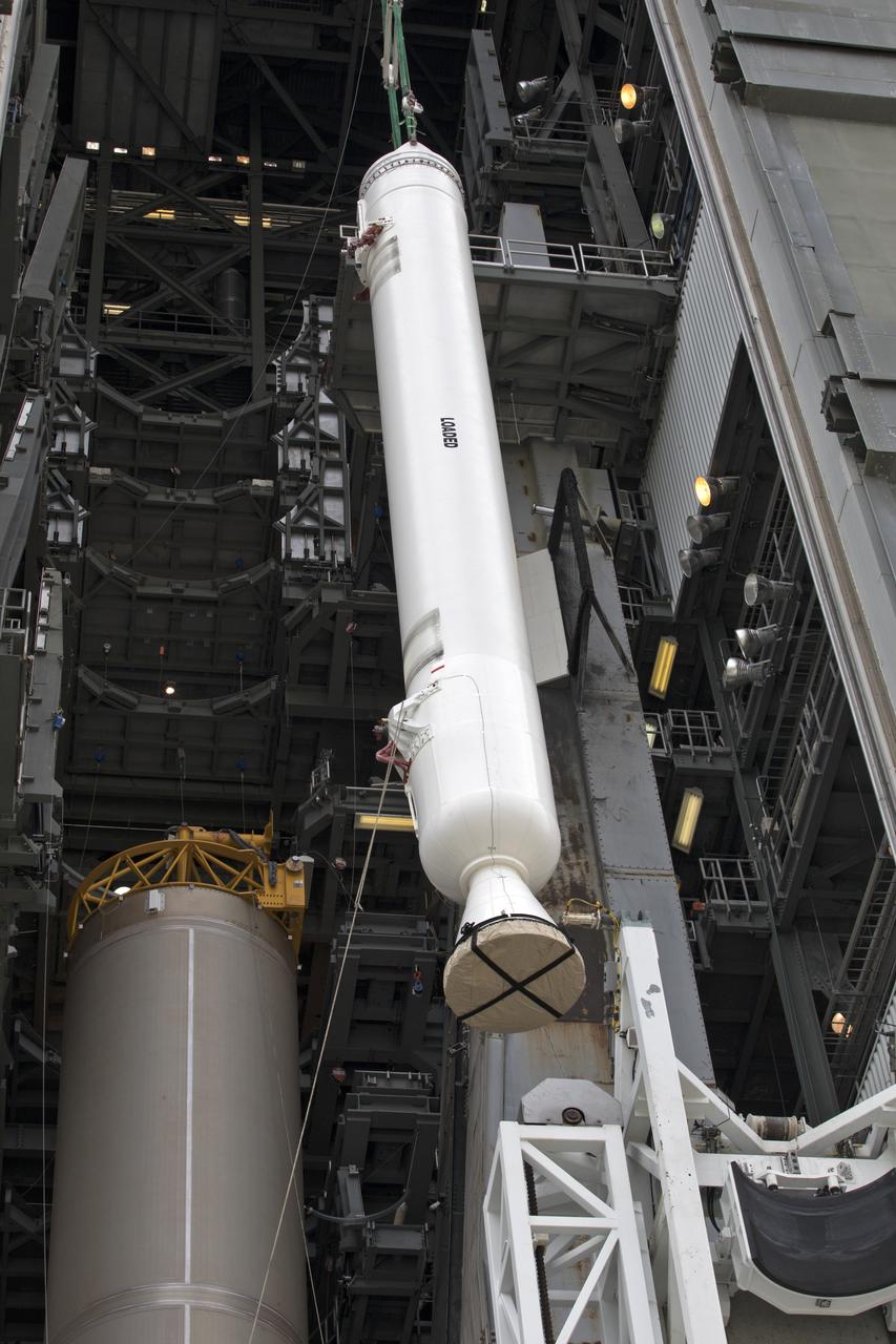 A crane lifts a solid rocket booster (SRB) for mating to a United Launch Alliance Atlas V first stage in the Vertical Integration Facility at Space Launch Complex 41 at Cape Canaveral Air Force Station in Florida. The SRB will be help boost NOAA's Geostationary Operational Environmental Satellite, or GOES-S, to orbit. GOES-S is the second in a series of four advanced geostationary weather satellites that will significantly improve the detection and observation of environmental phenomena that directly affect public safety, protection of property and the nation's economic health and prosperity. GOES-S is slated to launch March 1, 2018.
