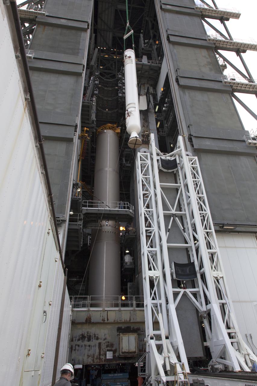 A crane lifts a solid rocket booster (SRB) for mating to a United Launch Alliance Atlas V first stage in the Vertical Integration Facility at Space Launch Complex 41 at Cape Canaveral Air Force Station in Florida. The SRB will be help boost NOAA's Geostationary Operational Environmental Satellite, or GOES-S, to orbit. GOES-S is the second in a series of four advanced geostationary weather satellites that will significantly improve the detection and observation of environmental phenomena that directly affect public safety, protection of property and the nation's economic health and prosperity. GOES-S is slated to launch March 1, 2018.