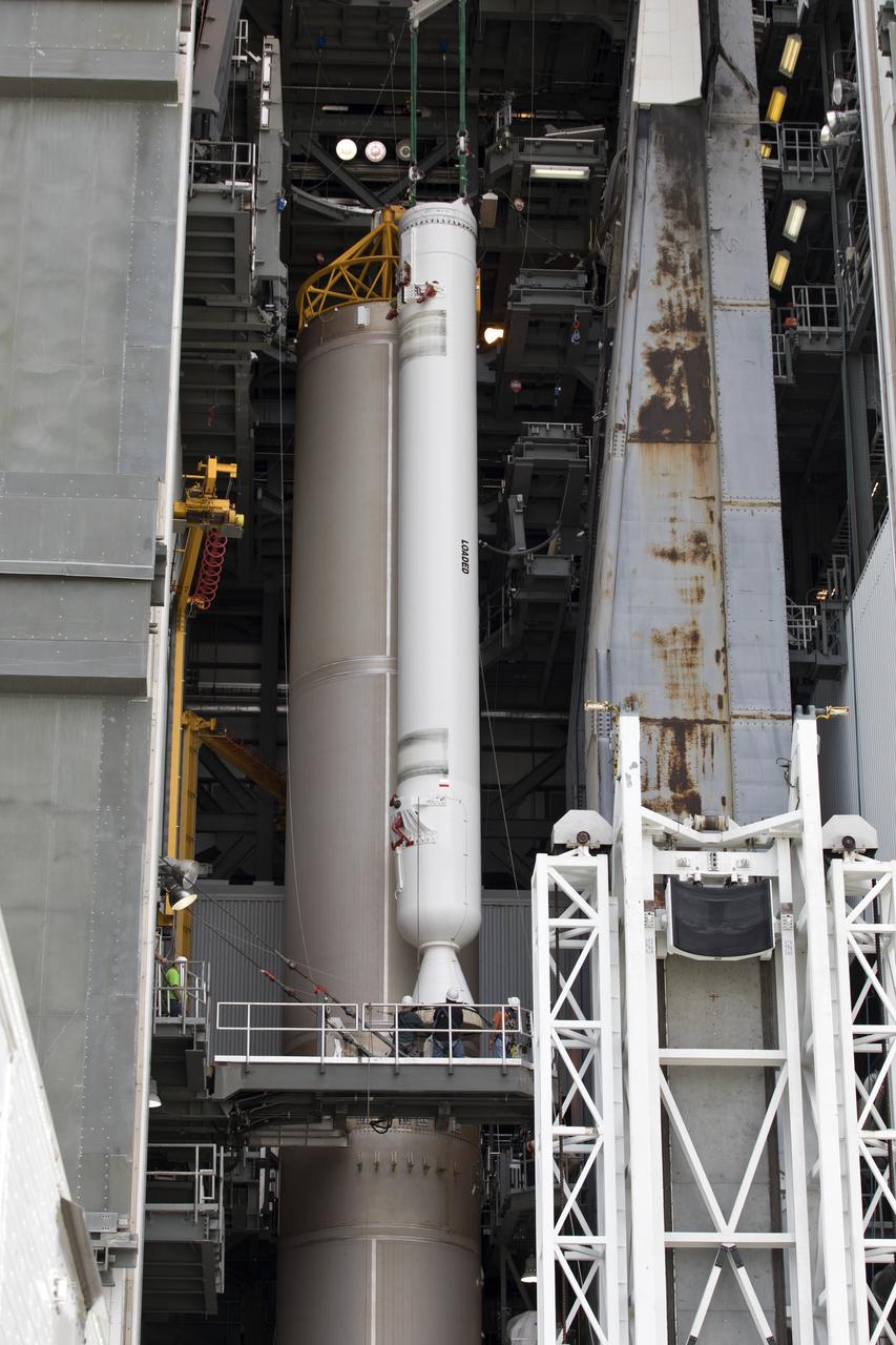 A crane lifts a solid rocket booster (SRB) for mating to a United Launch Alliance Atlas V first stage in the Vertical Integration Facility at Space Launch Complex 41 at Cape Canaveral Air Force Station in Florida. The SRB will be help boost NOAA's Geostationary Operational Environmental Satellite, or GOES-S, to orbit. GOES-S is the second in a series of four advanced geostationary weather satellites that will significantly improve the detection and observation of environmental phenomena that directly affect public safety, protection of property and the nation's economic health and prosperity. GOES-S is slated to launch March 1, 2018.