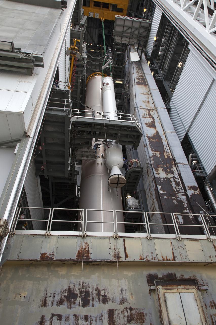 A solid rocket booster (SRB) is mated to a United Launch Alliance Atlas V first stage in the Vertical Integration Facility at Space Launch Complex 41 at Cape Canaveral Air Force Station in Florida. The SRB will be help boost NOAA's Geostationary Operational Environmental Satellite, or GOES-S, to orbit. GOES-S is the second in a series of four advanced geostationary weather satellites that will significantly improve the detection and observation of environmental phenomena that directly affect public safety, protection of property and the nation's economic health and prosperity. GOES-S is slated to launch March 1, 2018.