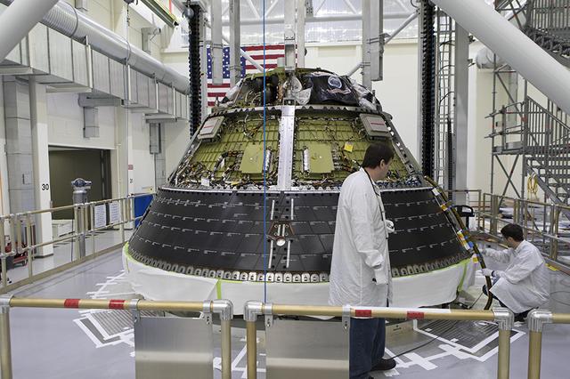 Lockheed Martin technicians test the fitting of the Orion spacecraft's heat shield back shell panels inside the Neil Armstrong Operations and Checkout Building high bay at NASA's Kennedy Space Center in Florida. The back shell panels serve as the outer layer of the spacecraft and will protect it against the extreme temperatures of re-entry from deep space. Orion is being prepared for its first integrated uncrewed flight atop NASA's Space Launch System rocket on Exploration Mission-1 from Launch Pad 39B at Kennedy Space Center.
