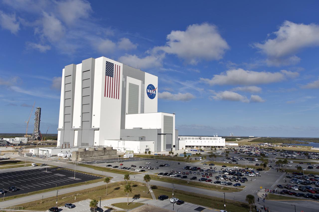 A SpaceX Falcon Heavy stands at Launch Complex 39A, far right, at NASA's Kennedy Space Center in Florida awaiting liftoff on its demonstration flight. In the foreground is the center’s iconic Vehicle Assembly Building. The demonstration flight is a significant milestone for the world's premier multi-user spaceport. In 2014, NASA signed a property agreement with SpaceX for the use and operation of the center's pad 39A, where the company has launched Falcon 9 rockets and is preparing for the first Falcon Heavy. NASA also has Space Act Agreements in place with partners, such as SpaceX, to provide services needed to process and launch rockets and spacecraft.