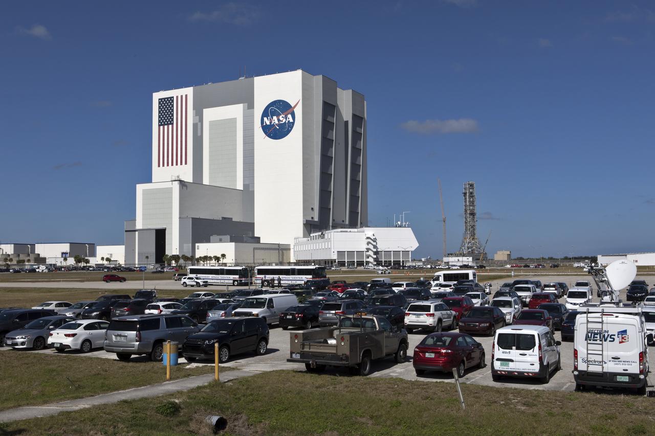 The parking area at the NASA News Center is filled with media vehicles and guest buses in anticipation of the liftoff of the SpaceX Falcon Heavy rocket from Launch Complex 39A at Kennedy Space Center in Florida. The demonstration flight will be a significant milestone for the world's premier multi-user spaceport. In 2014, NASA signed a property agreement with SpaceX for the use and operation of the center's pad 39A, where the company has launched Falcon 9 rockets and is preparing for the first Falcon Heavy. NASA also has Space Act Agreements in place with partners, such as SpaceX, to provide services needed to process and launch rockets and spacecraft.