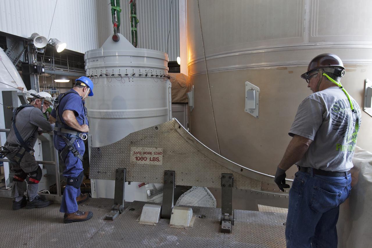 At the Vertical Integration Facility at Space Launch Complex 41 at Cape Canaveral Air Force Station in Florida, technicians support operations to mate a solid rocket booster (SRB) to a United Launch Alliance Atlas V first stage. The SRB will help boost NOAA's Geostationary Operational Environmental Satellite, or GOES-S, to orbit. GOES-S is the second in a series of four advanced geostationary weather satellites that will significantly improve the detection and observation of environmental phenomena that directly affect public safety, protection of property and the nation's economic health and prosperity. GOES-S is slated to launch March 1, 2018.