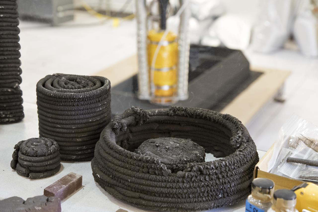 Pellets made from simulated lunar regolith, or dirt, and polymers are being used to test a Zero Launch Mass 3-D printer in the Swamp Works at NASA's Kennedy Space Center in Florida. The printer can be used for construction projects on the Moon and Mars, and even for troops in remote locations on Earth. Zero launch mass refers to the fact that the printer uses these pellets to prove that space explorers can use resources at their destination instead of taking everything with them, saving them launch mass and money. The group is working with Marshall Space Flight Center in Huntsville, Alabama, and the U.S. Army Corps of Engineers to develop a system that can 3-D print barracks in remote locations on Earth, using the resources they have where they are. 