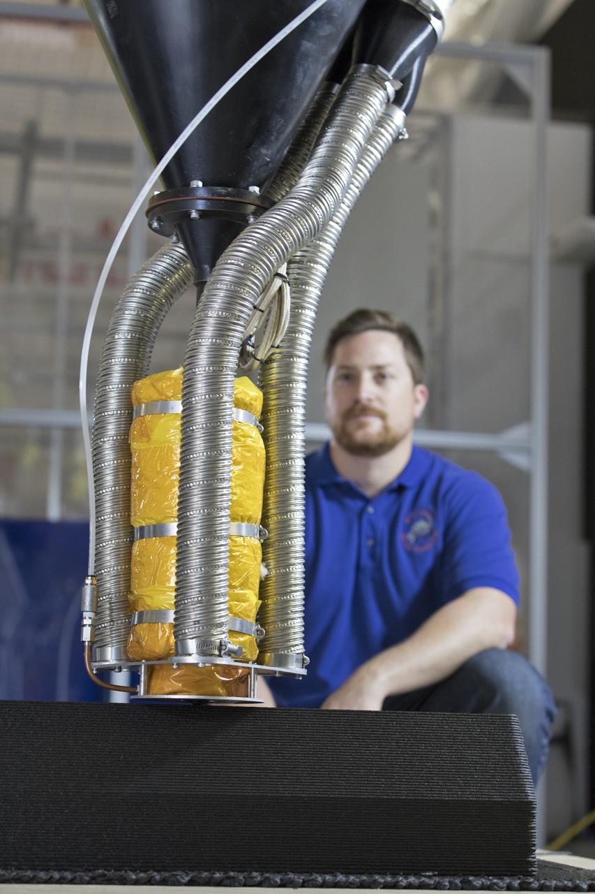 Nathan Gelino, a NASA research engineer at Kennedy Space Center in Florida, is working on a Zero Launch Mass 3-D printer in the center's Swamp Works that can be used for construction projects on the Moon and Mars, and even for troops in remote locations here on Earth. Zero launch mass refers to the fact that the printer uses pellets made from simulated lunar regolith, or dirt, and polymers to prove that space explorers can use resources at their destination instead of taking everything with them, saving them launch mass and money. Gelino and his team are working with Marshall Space Flight Center in Huntsville, Alabama, and the U.S. Army Corps of Engineers to develop a system that can 3-D print barracks in remote locations on Earth, using the resources they have where they are.