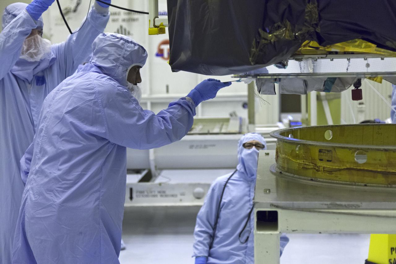 Technicians dressed in clean room suits monitor the progress as a crane lowers NASA's Transiting Exoplanet Survey Satellite (TESS) onto a test stand inside the Payload Hazardous Servicing Facility (PHSF) at the agency's Kennedy Space Center in Florida. Inside the PHSF, the satellite will be processed and prepared for its flight. TESS is scheduled to launch atop a SpaceX Falcon 9 rocket from Space Launch Complex 40 at Cape Canaveral Air Force Station. TESS is the next step in NASA's search for planets outside our solar system, known as exoplanets. TESS is a NASA Astrophysics Explorer mission led and operated by MIT in Cambridge, Massachusetts, and managed by NASA’s Goddard Space Flight Center in Greenbelt, Maryland. Dr. George Ricker of MIT’s Kavli Institute for Astrophysics and Space Research serves as principal investigator for the mission. Additional partners include Orbital ATK, NASA’s Ames Research Center, the Harvard-Smithsonian Center for Astrophysics and the Space Telescope Science Institute. More than a dozen universities, research institutes and observatories worldwide are participants in the mission. NASA’s Launch Services Program is responsible for launch management. 