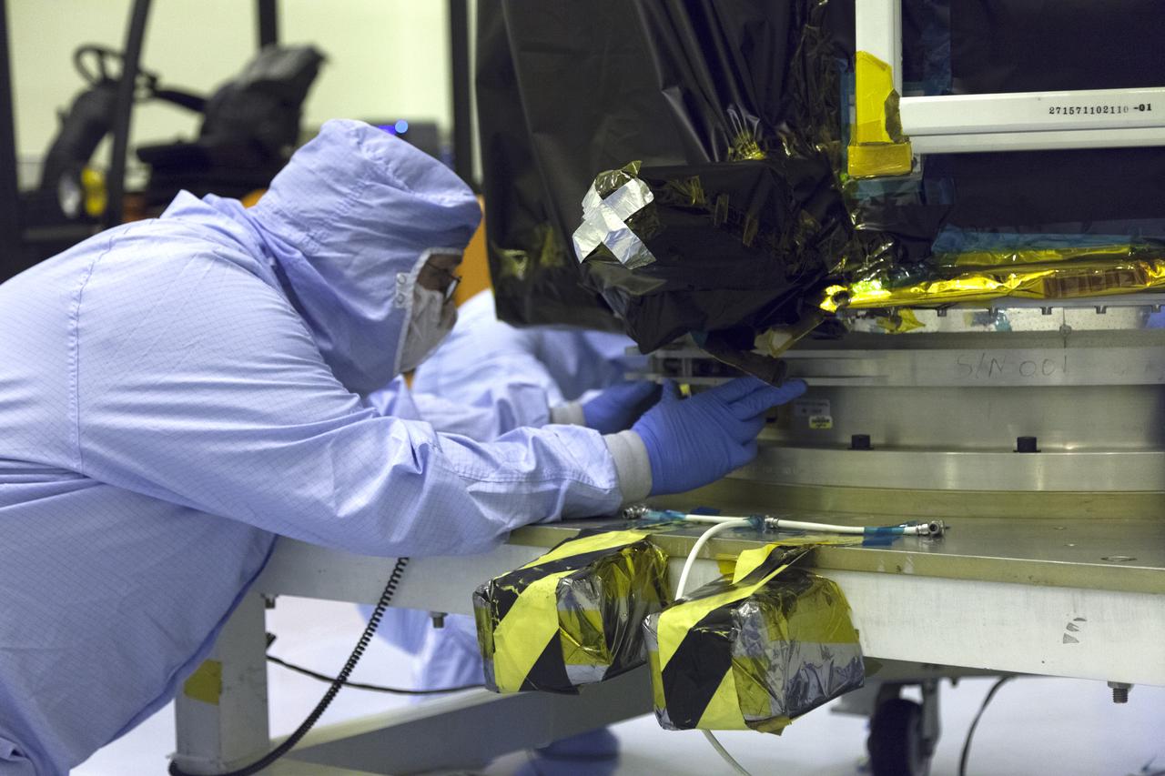 A technician dressed in a clean room suit closely monitors the progress as a crane lowers NASA's Transiting Exoplanet Survey Satellite (TESS) onto a test stand inside the Payload Hazardous Servicing Facility (PHSF) at the agency's Kennedy Space Center in Florida. Inside the PHSF, the satellite will be processed and prepared for its flight. TESS is scheduled to launch atop a SpaceX Falcon 9 rocket from Space Launch Complex 40 at Cape Canaveral Air Force Station. TESS is the next step in NASA's search for planets outside our solar system, known as exoplanets. TESS is a NASA Astrophysics Explorer mission led and operated by MIT in Cambridge, Massachusetts, and managed by NASA’s Goddard Space Flight Center in Greenbelt, Maryland. Dr. George Ricker of MIT’s Kavli Institute for Astrophysics and Space Research serves as principal investigator for the mission. Additional partners include Orbital ATK, NASA’s Ames Research Center, the Harvard-Smithsonian Center for Astrophysics and the Space Telescope Science Institute. More than a dozen universities, research institutes and observatories worldwide are participants in the mission. NASA’s Launch Services Program is responsible for launch management. 