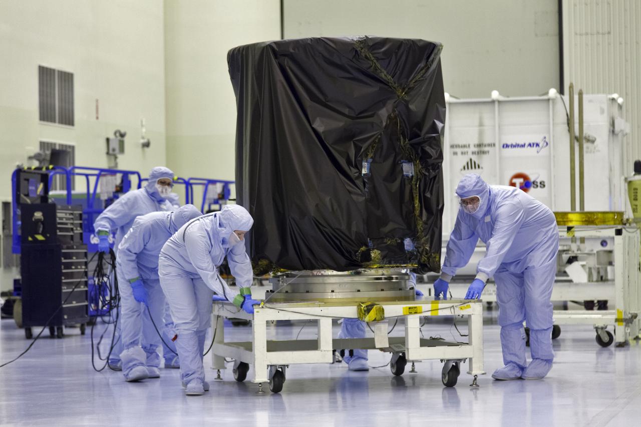 Technicians dressed in clean room suits move NASA's Transiting Exoplanet Survey Satellite (TESS) secured on a test stand inside the Payload Hazardous Servicing Facility (PHSF) at the agency's Kennedy Space Center in Florida. Inside the PHSF, the satellite will be processed and prepared for its flight. TESS is scheduled to launch atop a SpaceX Falcon 9 rocket from Space Launch Complex 40 at Cape Canaveral Air Force Station. TESS is the next step in NASA's search for planets outside our solar system, known as exoplanets. TESS is a NASA Astrophysics Explorer mission led and operated by MIT in Cambridge, Massachusetts, and managed by NASA’s Goddard Space Flight Center in Greenbelt, Maryland. Dr. George Ricker of MIT’s Kavli Institute for Astrophysics and Space Research serves as principal investigator for the mission. Additional partners include Orbital ATK, NASA’s Ames Research Center, the Harvard-Smithsonian Center for Astrophysics and the Space Telescope Science Institute. More than a dozen universities, research institutes and observatories worldwide are participants in the mission. NASA’s Launch Services Program is responsible for launch management.