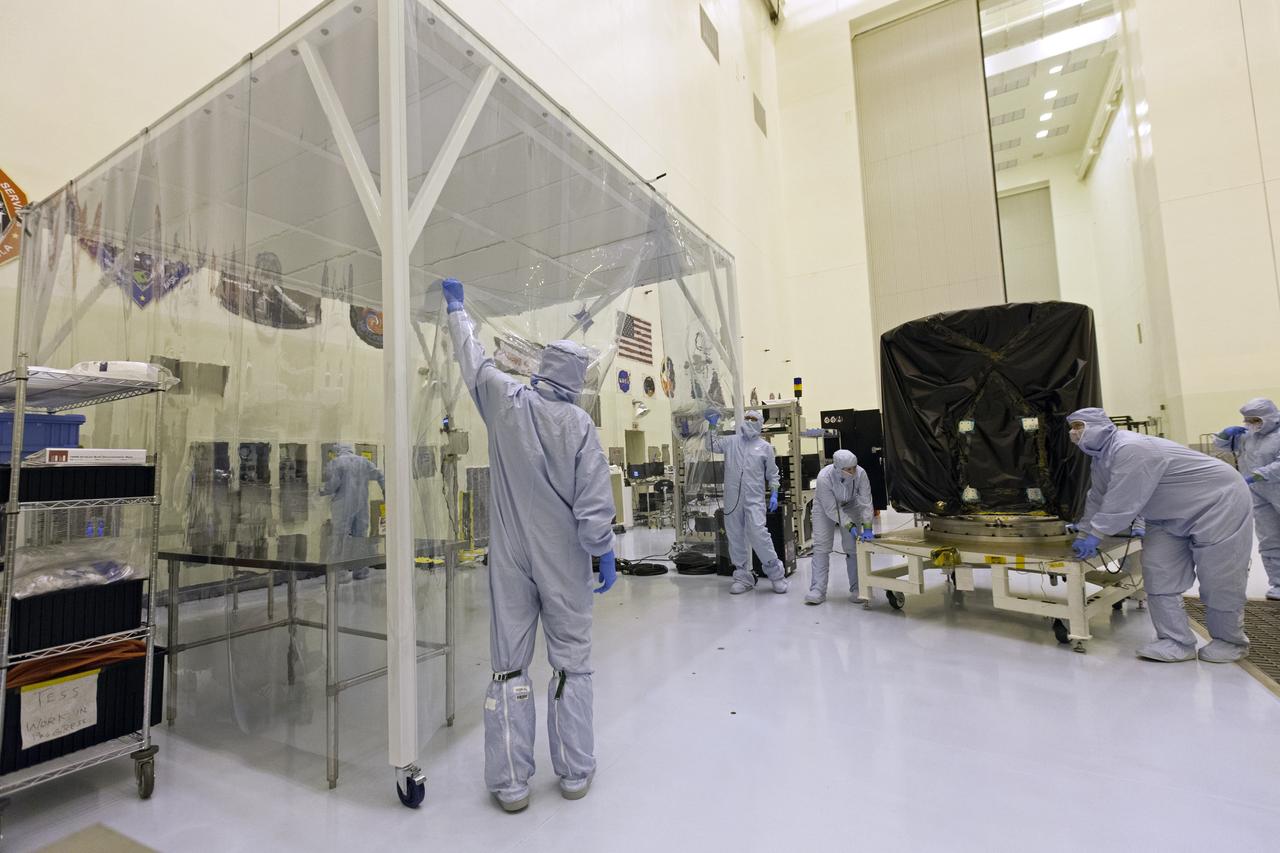 Technician dressed in clean room suits move NASA's Transiting Exoplanet Survey Satellite (TESS) on a test stand to a clean room tent inside the Payload Hazardous Servicing Facility (PHSF) at the agency's Kennedy Space Center in Florida. Inside the PHSF, the satellite will be processed and prepared for its flight. TESS is scheduled to launch atop a SpaceX Falcon 9 rocket from Space Launch Complex 40 at Cape Canaveral Air Force Station. TESS is the next step in NASA's search for planets outside our solar system, known as exoplanets. TESS is a NASA Astrophysics Explorer mission led and operated by MIT in Cambridge, Massachusetts, and managed by NASA’s Goddard Space Flight Center in Greenbelt, Maryland. Dr. George Ricker of MIT’s Kavli Institute for Astrophysics and Space Research serves as principal investigator for the mission. Additional partners include Orbital ATK, NASA’s Ames Research Center, the Harvard-Smithsonian Center for Astrophysics and the Space Telescope Science Institute. More than a dozen universities, research institutes and observatories worldwide are participants in the mission. NASA’s Launch Services Program is responsible for launch management. 