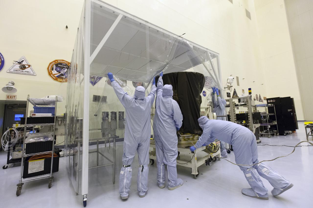 Technician dressed in clean room suits move NASA's Transiting Exoplanet Survey Satellite (TESS) on a test stand into a clean room tent inside the Payload Hazardous Servicing Facility (PHSF) at the agency's Kennedy Space Center in Florida. Inside the PHSF, the satellite will be processed and prepared for its flight. TESS is scheduled to launch atop a SpaceX Falcon 9 rocket from Space Launch Complex 40 at Cape Canaveral Air Force Station. TESS is the next step in NASA's search for planets outside our solar system, known as exoplanets. TESS is a NASA Astrophysics Explorer mission led and operated by MIT in Cambridge, Massachusetts, and managed by NASA’s Goddard Space Flight Center in Greenbelt, Maryland. Dr. George Ricker of MIT’s Kavli Institute for Astrophysics and Space Research serves as principal investigator for the mission. Additional partners include Orbital ATK, NASA’s Ames Research Center, the Harvard-Smithsonian Center for Astrophysics and the Space Telescope Science Institute. More than a dozen universities, research institutes and observatories worldwide are participants in the mission. NASA’s Launch Services Program is responsible for launch management.