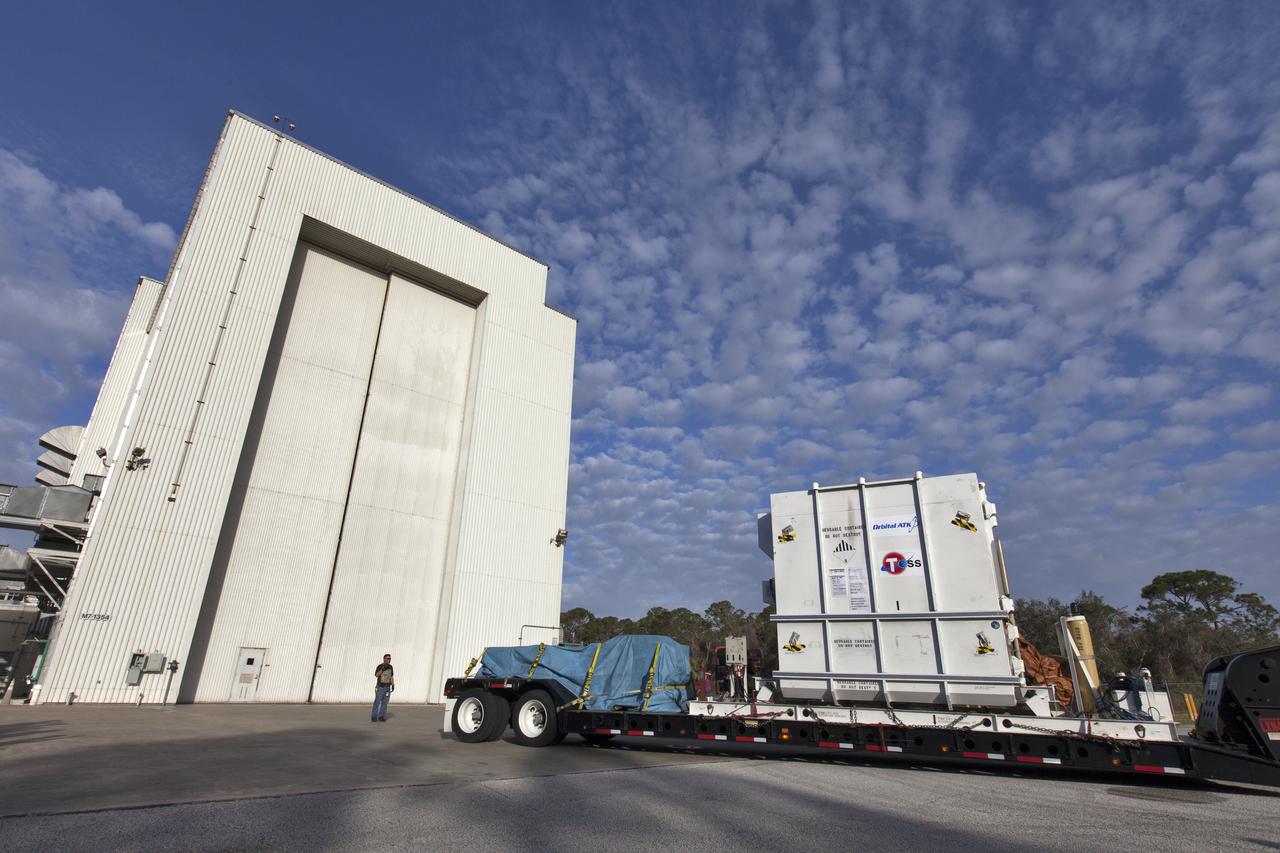 NASA's Transiting Exoplanet Survey Satellite (TESS), inside its shipping container, is backed in on flatbed truck to the Payload Hazardous Servicing Facility (PHSF) at the agency's Kennedy Space Center in Florida. Inside the PHSF, the satellite will be processed and prepared for its flight. TESS is scheduled to launch atop a SpaceX Falcon 9 rocket from Space Launch Complex 40 at Cape Canaveral Air Force Station. TESS is the next step in NASA's search for planets outside our solar system, known as exoplanets. TESS is a NASA Astrophysics Explorer mission led and operated by MIT in Cambridge, Massachusetts, and managed by NASA’s Goddard Space Flight Center in Greenbelt, Maryland. Dr. George Ricker of MIT’s Kavli Institute for Astrophysics and Space Research serves as principal investigator for the mission. Additional partners include Orbital ATK, NASA’s Ames Research Center, the Harvard-Smithsonian Center for Astrophysics and the Space Telescope Science Institute. More than a dozen universities, research institutes and observatories worldwide are participants in the mission. NASA’s Launch Services Program is responsible for launch management. 