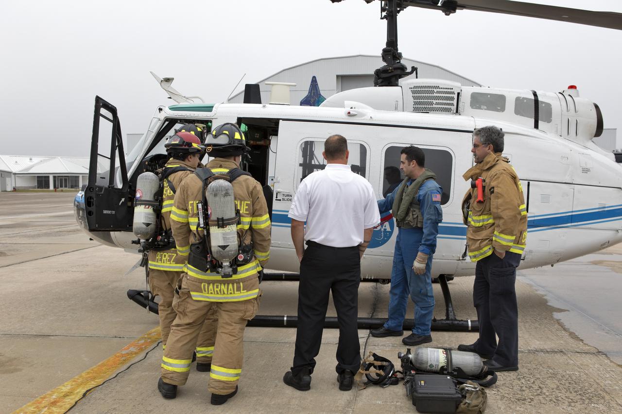 NASA Kennedy Space Center's Flight Operations team reviews procedures before beginning a rehearsal of a helicopter crash-landing to test new and updated emergency procedures. Called the Aircraft Mishap Preparedness and Contingency Plan, the operation was designed to validate several updated techniques the center's first responders would follow, should they ever need to rescue a crew in case of a real accident. The mishap exercise took place at the center's Shuttle Landing Facility. 