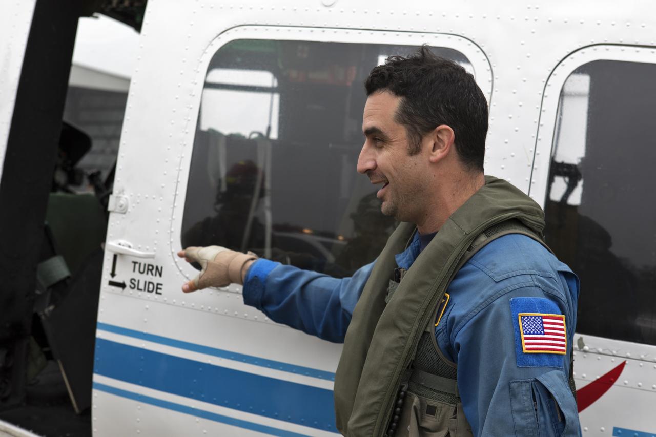 A member of NASA Kennedy Space Center's Flight Operations team prepares for a rehearsal of a helicopter crash-landing to test new and updated emergency procedures. Called the Aircraft Mishap Preparedness and Contingency Plan, the operation was designed to validate several updated techniques the center's first responders would follow, should they ever need to rescue a crew in case of a real accident. The mishap exercise took place at the center's Shuttle Landing Facility. 