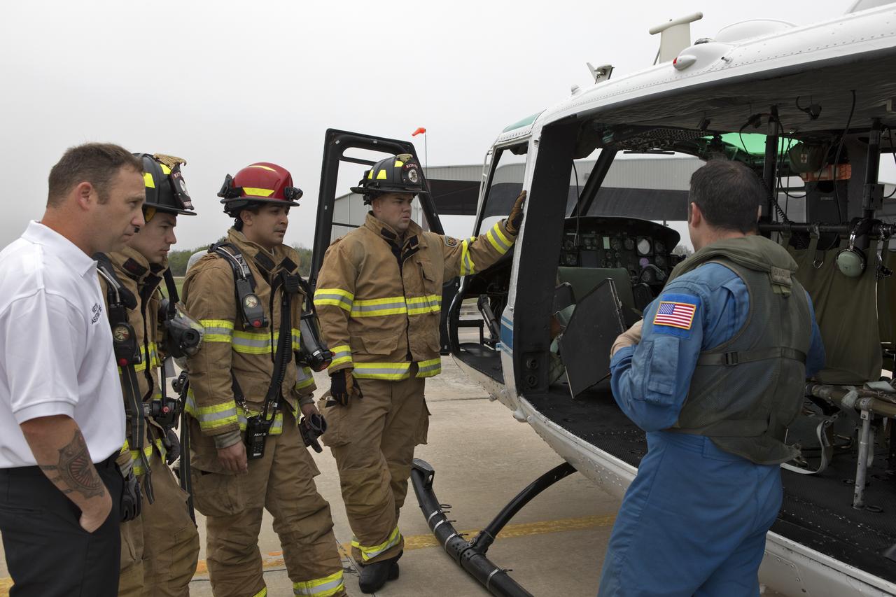 NASA Kennedy Space Center's Flight Operations team reviews procedures before beginning a rehearsal of a helicopter crash-landing to test new and updated emergency procedures. Called the Aircraft Mishap Preparedness and Contingency Plan, the operation was designed to validate several updated techniques the center's first responders would follow, should they ever need to rescue a crew in case of a real accident. The mishap exercise took place at the center's Shuttle Landing Facility.