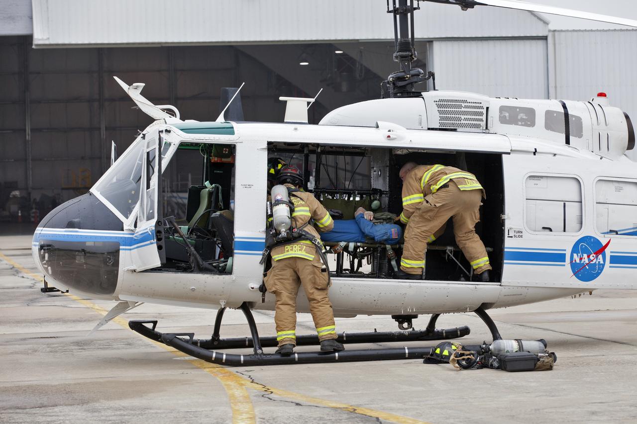 Members of NASA Kennedy Space Center's Flight Operations team participate in a rehearsal of a helicopter crash-landing to test new and updated emergency procedures. Called the Aircraft Mishap Preparedness and Contingency Plan, the operation was designed to validate several updated techniques the center's first responders would follow, should they ever need to rescue a crew in case of a real accident. The mishap exercise took place at the center's Shuttle Landing Facility. 