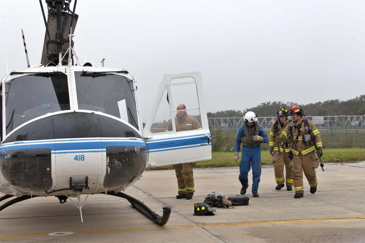 Members of NASA Kennedy Space Center's Flight Operations team participate in a rehearsal of a helicopter crash-landing to test new and updated emergency procedures. Called the Aircraft Mishap Preparedness and Contingency Plan, the operation was designed to validate several updated techniques the center's first responders would follow, should they ever need to rescue a crew in case of a real accident. The mishap exercise took place at the center's Shuttle Landing Facility. 