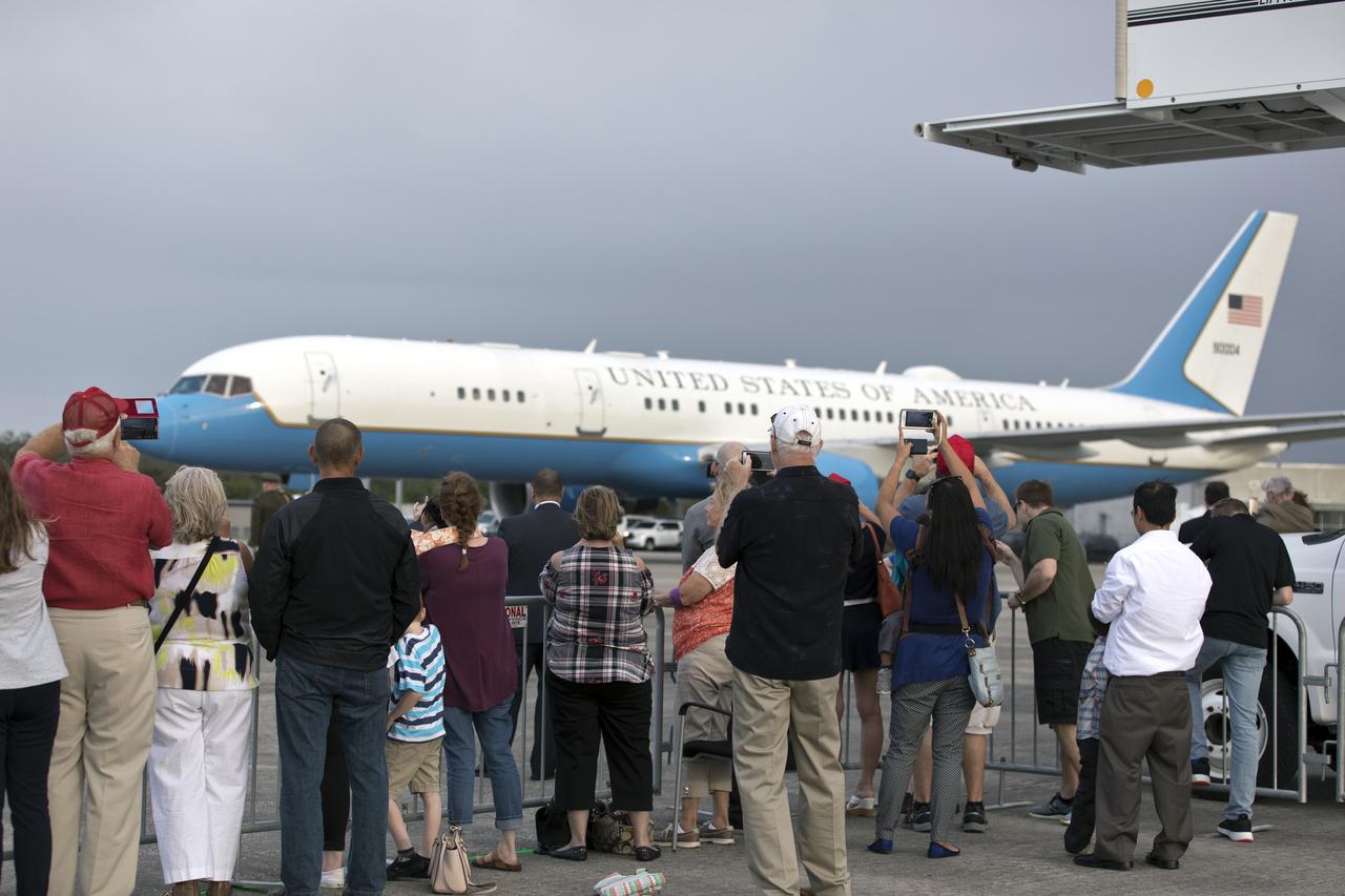 Spectators watch as Air Force Two, carrying Vice President Mike Pence, taxis on the Shuttle Landing Facility at NASA's Kennedy Space Center in Florida, on Feb. 20, 2018. During his visit, Pence will chair a meeting of the National Space Council in the high bay of the center's Space Station Processing Facility. The council's role is to advise the president regarding national space policy and strategy, and review the nation's long-range goals for space activities. 