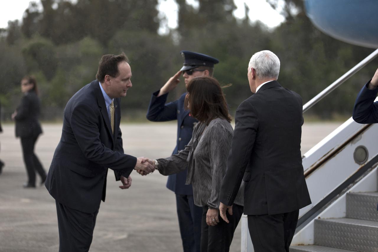 Acting NASA Administrator Robert Lightfoot, left, greets Vice President Mike Pence and his wife, Karen, after their arrival aboard Air Force Two at the Shuttle Landing Facility at NASA's Kennedy Space Center in Florida, on Feb. 20, 2018. During his visit, Pence will chair a meeting of the National Space Council in the high bay of the center's Space Station Processing Facility. The council's role is to advise the president regarding national space policy and strategy, and review the nation's long-range goals for space activities.