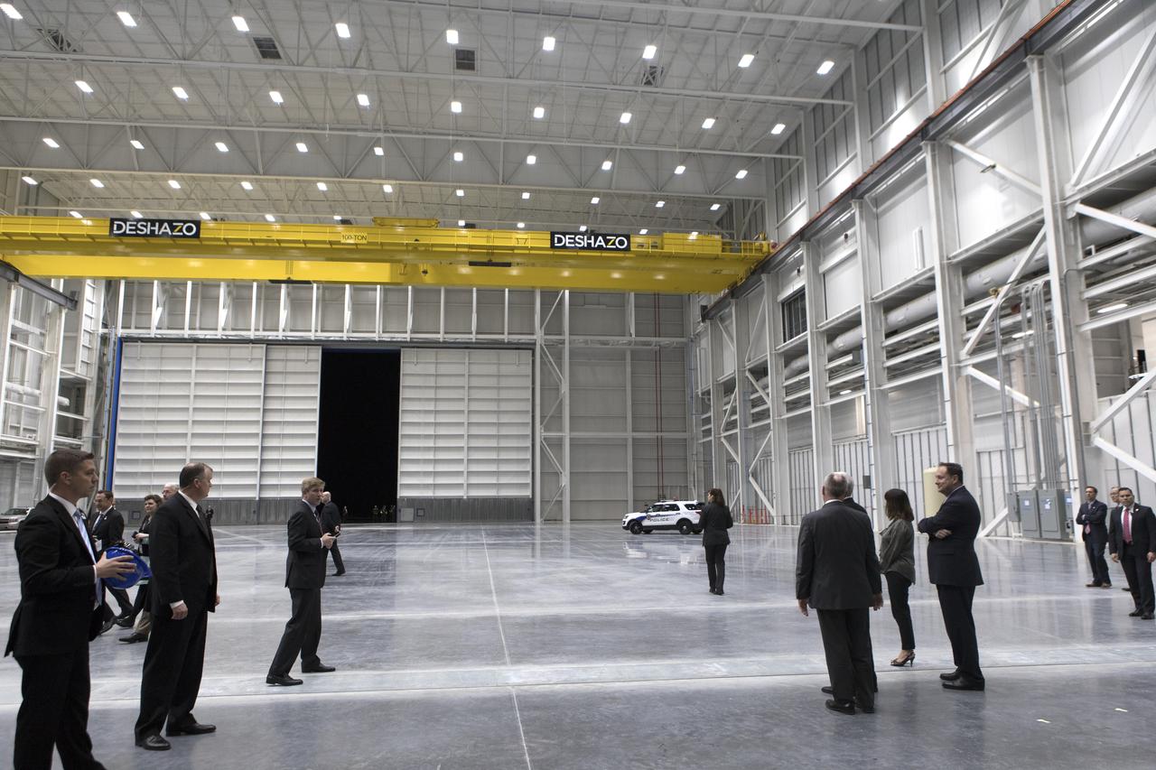 Vice President Mike Pence, hidden at right, tours the Blue Origin Manufacturing Facility near NASA's Kennedy Space Center in Florida, on Feb. 20, 2018. At far right is the vice president's wife, Karen Pence. Behind her at right are Blue Origin CEO Robert Smith, and acting NASA Administrator Robert Lightfoot. Vice President Pence viewed the flown New Shepard Booster and Crew Capsule. The booster was the first launch vehicle with a successful vertical takeoff and vertical landing to demonstrate reusability. During his visit, Pence will chair a meeting of the National Space Council on Feb. 21, 2018 in the high bay of NASA Kennedy Space Center's Space Station Processing Facility. The council's role is to advise the president regarding national space policy and strategy, and review the nation's long-range goals for space activities. 