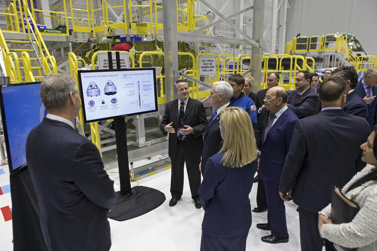 Vice President Mike Pence, center, and members of the National Space Council hear from a Boeing employee during a tour of the Boeing Commercial Crew and Cargo Processing Facility at NASA's Kennedy Space Center in Florida, on Feb. 21, 2018. During his visit, Pence chaired a meeting of the council in the high bay of the center's Space Station Processing Facility. The council's role is to advise the president regarding national space policy and strategy, and review the nation's long-range goals for space activities.