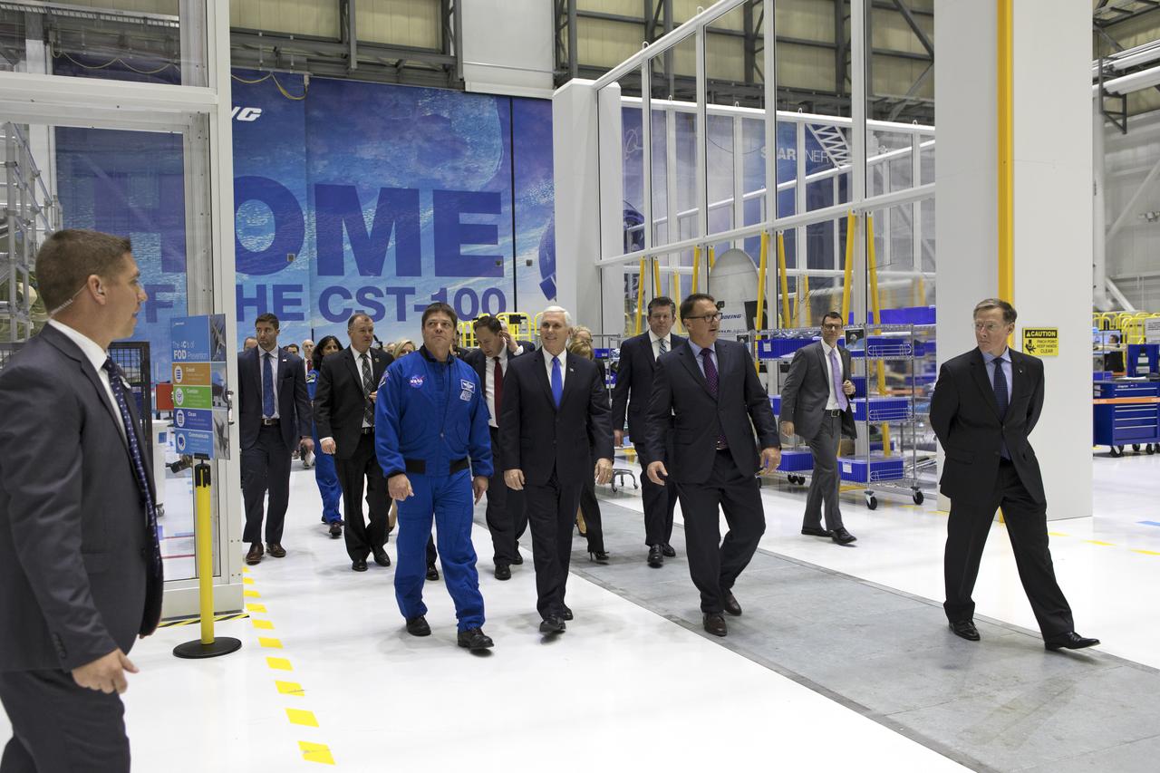 Vice President Mike Pence, left, is flanked by NASA astronaut Bob Behnken, left, John Mulholland, Boeing vice president and program manager for Commercial Crew Programs, and Chris Ferguson, Boeing’s director of Crew and Mission Systems, during a tour of the company’s Commercial Crew and Cargo Processing Facility at NASA's Kennedy Space Center in Florida, on Feb. 21, 2018. During his visit, Pence chaired a meeting of the National Space Council in the high bay of the center's Space Station Processing Facility. The council's role is to advise the president regarding national space policy and strategy, and review the nation's long-range goals for space activities.